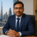 Indian real estate CEO Shailendra Sharma at his Dubai office, discussing property trends for Indian investors.