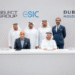 Khalid Al Malik and Rahail Aslam seated together during the signing of the strategic partnership between Dubai Holding and Select Group.
