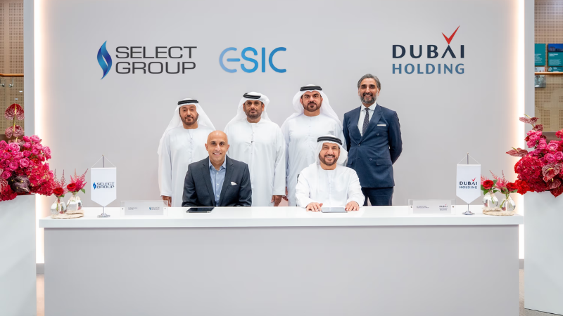 Khalid Al Malik and Rahail Aslam seated together during the signing of the strategic partnership between Dubai Holding and Select Group.