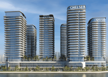 A high-resolution aerial rendering of Chelsea Residences by DAMAC in Dubai Maritime City, featuring waterfront luxury towers against the Dubai skyline at sunset.