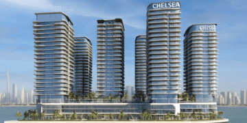 A high-resolution aerial rendering of Chelsea Residences by DAMAC in Dubai Maritime City, featuring waterfront luxury towers against the Dubai skyline at sunset.