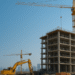 Aerial view of Dubai skyline with major real estate development sites under construction.