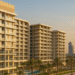 Exterior view of a modern Danube Properties residential tower in Dubai with landscaped surroundings and contemporary architecture.