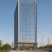 A modern commercial tower with a glass façade, located in a vibrant urban area of Dubai, surrounded by greenery and pedestrian-friendly spaces.