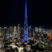 Dubai skyline at night featuring Burj Khalifa and Emaar buildings illuminated
