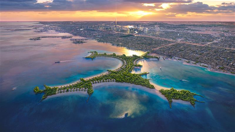 Aerial view of Naïa Island Dubai with luxury beachfront residences and Dubai skyline in the background during sunset