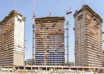 Azizi Rêve construction site showing façades and cranes at MBR City.