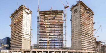 Azizi Rêve construction site showing façades and cranes at MBR City.