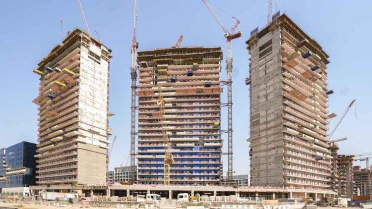 Azizi Rêve construction site showing façades and cranes at MBR City.