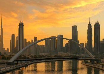 Aerial view of Dubai Water Canal and Business Bay skyline at sunset, showing luxury towers, bridges, and waterfront plots, symbolizing Dubai’s record AED 362 million land sale.