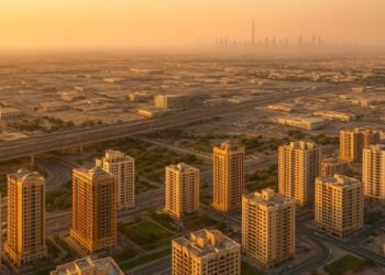 Sharjah real estate October 2025 showing residential and industrial developments with Dubai skyline in background
