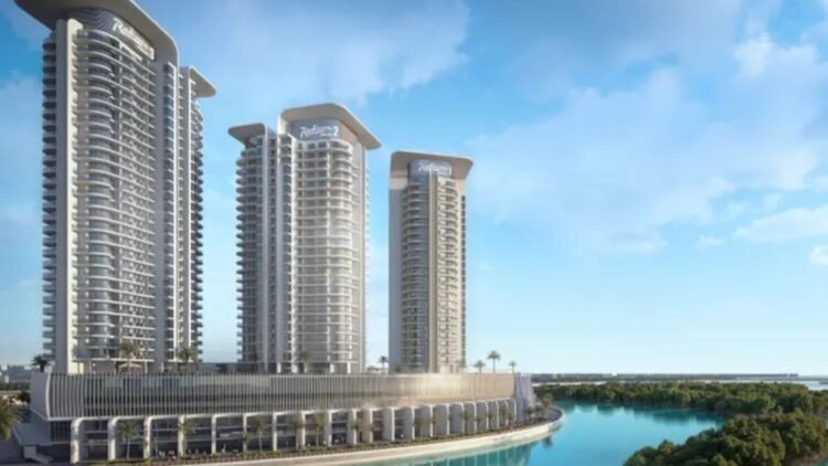 Aerial view of Radisson Residences Al Reem Island waterfront towers amid Abu Dhabi mangroves.