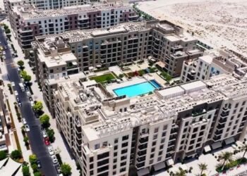 Aerial view of Sharjah off-plan projects Maryam Island and Sustainable City with waterfront and green spaces.