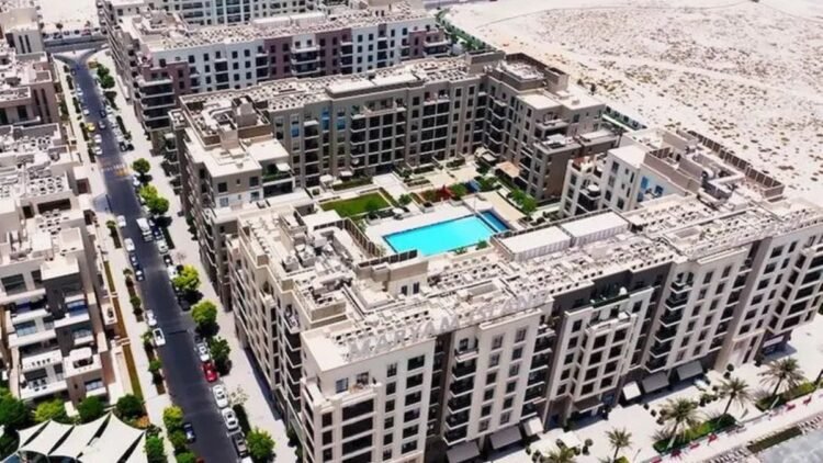 Aerial view of Sharjah off-plan projects Maryam Island and Sustainable City with waterfront and green spaces.