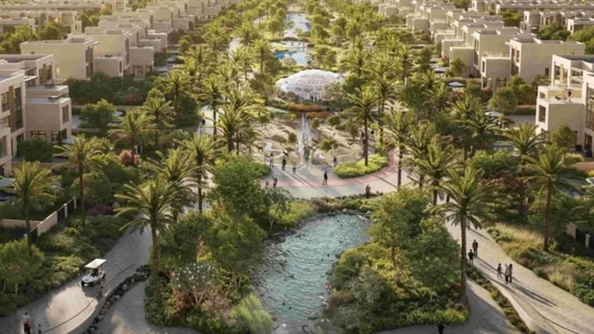 Aerial view of Sharjah sustainable residential community development in Al Rahmaniya with townhouses and green corridors.