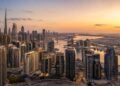 Aerial view of Dubai residential skyline at dusk with high-rise towers in Business Bay, reflecting Dubai real estate sales 2026 transaction volumes against a clear sky.
