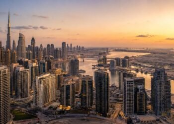 Aerial view of Dubai residential skyline at dusk with high-rise towers in Business Bay, reflecting Dubai real estate sales 2026 transaction volumes against a clear sky.