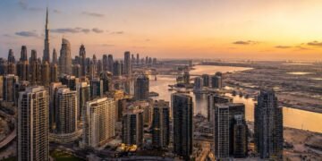 Aerial view of Dubai residential skyline at dusk with high-rise towers in Business Bay, reflecting Dubai real estate sales 2026 transaction volumes against a clear sky.