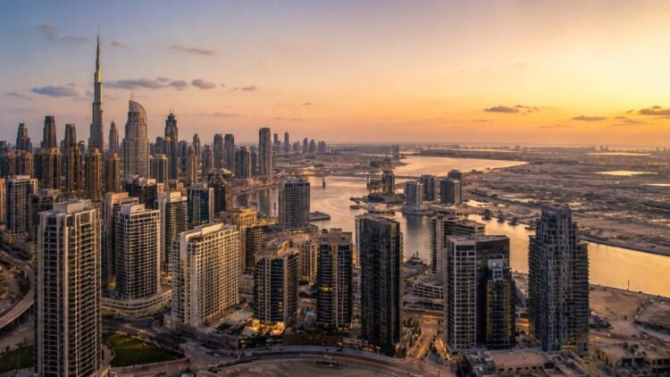 Aerial view of Dubai residential skyline at dusk with high-rise towers in Business Bay, reflecting Dubai real estate sales 2026 transaction volumes against a clear sky.