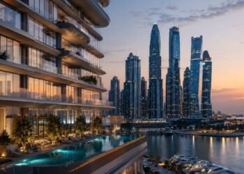 Waterfront tower in Dubai illustrating the Dubai branded residences premium, with hotel-branded apartments overlooking the marina at dusk