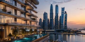Waterfront tower in Dubai illustrating the Dubai branded residences premium, with hotel-branded apartments overlooking the marina at dusk