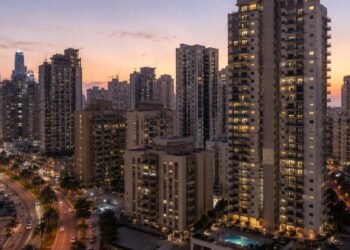 Apartment towers around Dubai Marina at dusk illustrating the Dubai Flexi Rent scheme that lets tenants pay rent in monthly installments