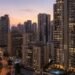 Apartment towers around Dubai Marina at dusk illustrating the Dubai Flexi Rent scheme that lets tenants pay rent in monthly installments