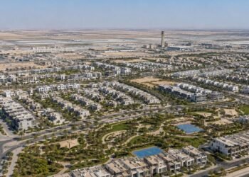 Aerial view of Dubai South master development showing residential communities and Al Maktoum International Airport in the background, representing Dubai South property investment 2026.