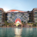 Topped-out concrete frame of The Unexpected Al Marjan Island Hotel & Residences in Ras Al Khaimah with façade work under way.